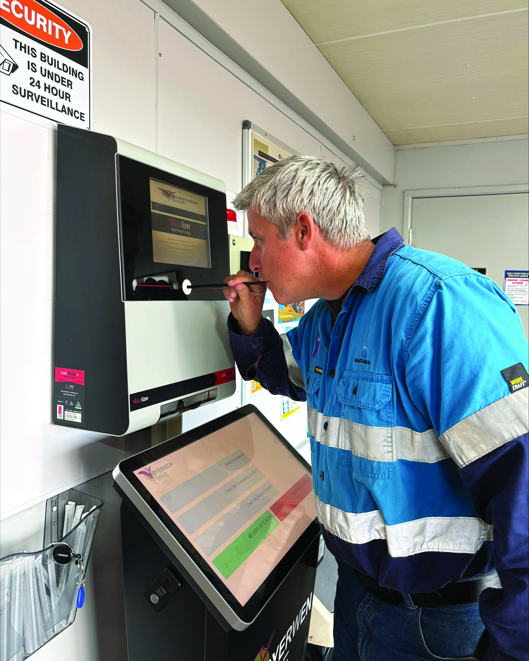 Alcolizer breathalyser integration in action — a worker provides a breath sample while the connected kiosk records the fit-for-work result.